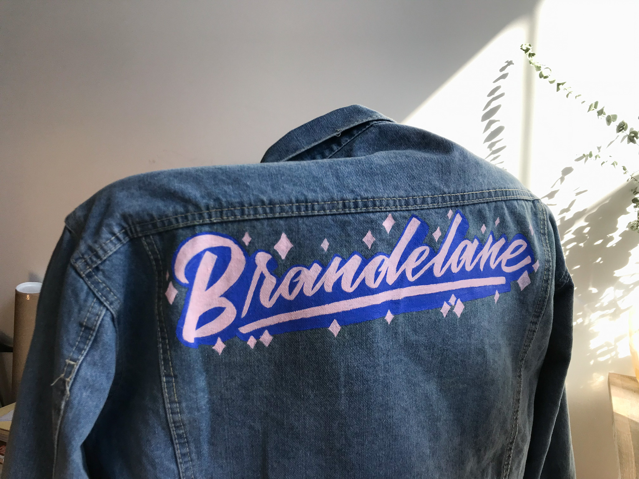 Hand painted custom lettering on denim jacket for Brandelane by Hillery Powers